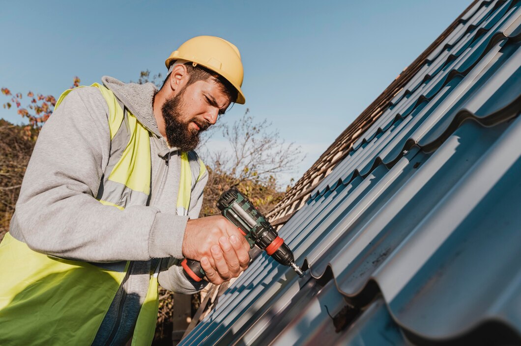 A worker using his tools doing roof installations.